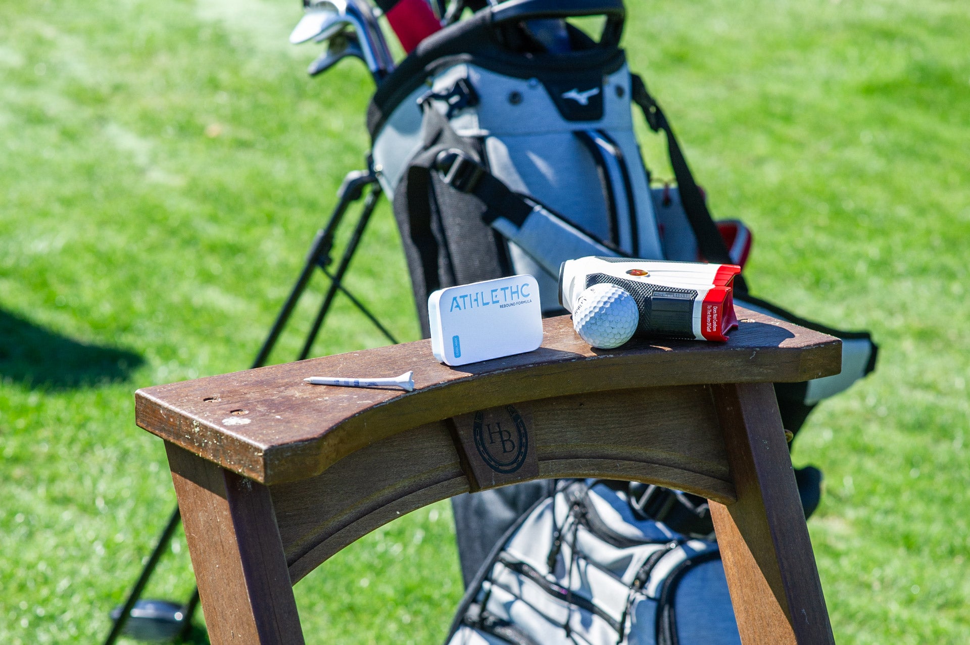 Tin of mints in front of golf gear