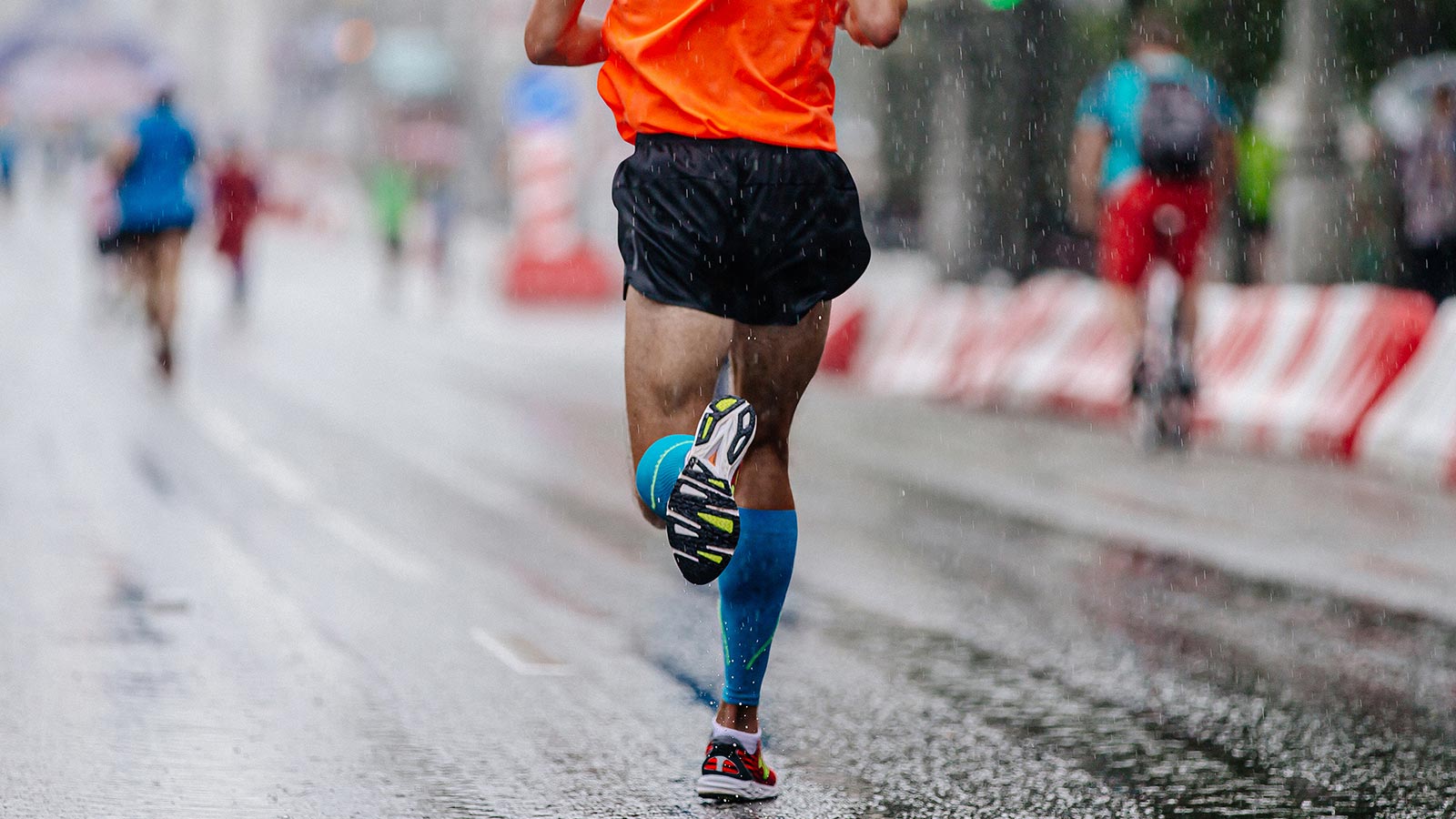 Marathon runner sprinting in the rain
