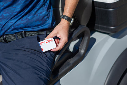 Golfer man pulling a tin of cinnamon Power Formula mints out of his pocket.