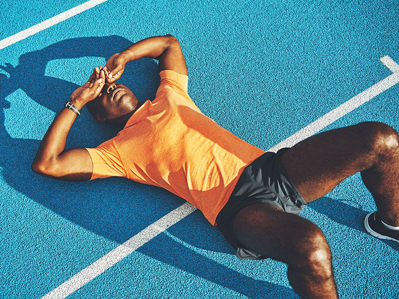 Exhausted athlete laying on the ground