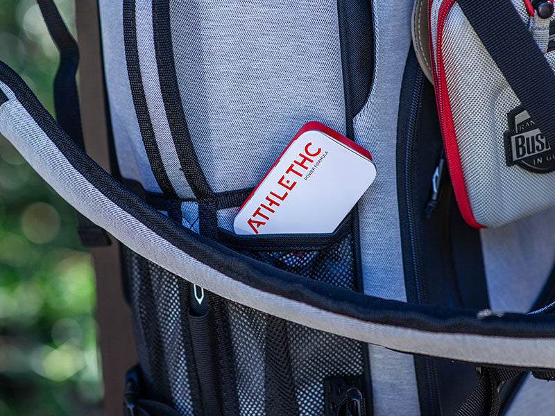 Tin of ATHLETHC Power Microdose THC mints in a golf bag