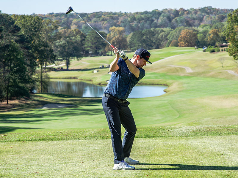 Man in athletic THC clothing golfing